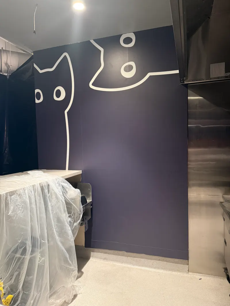 Cat mural feature wall in a commercial kitchen
