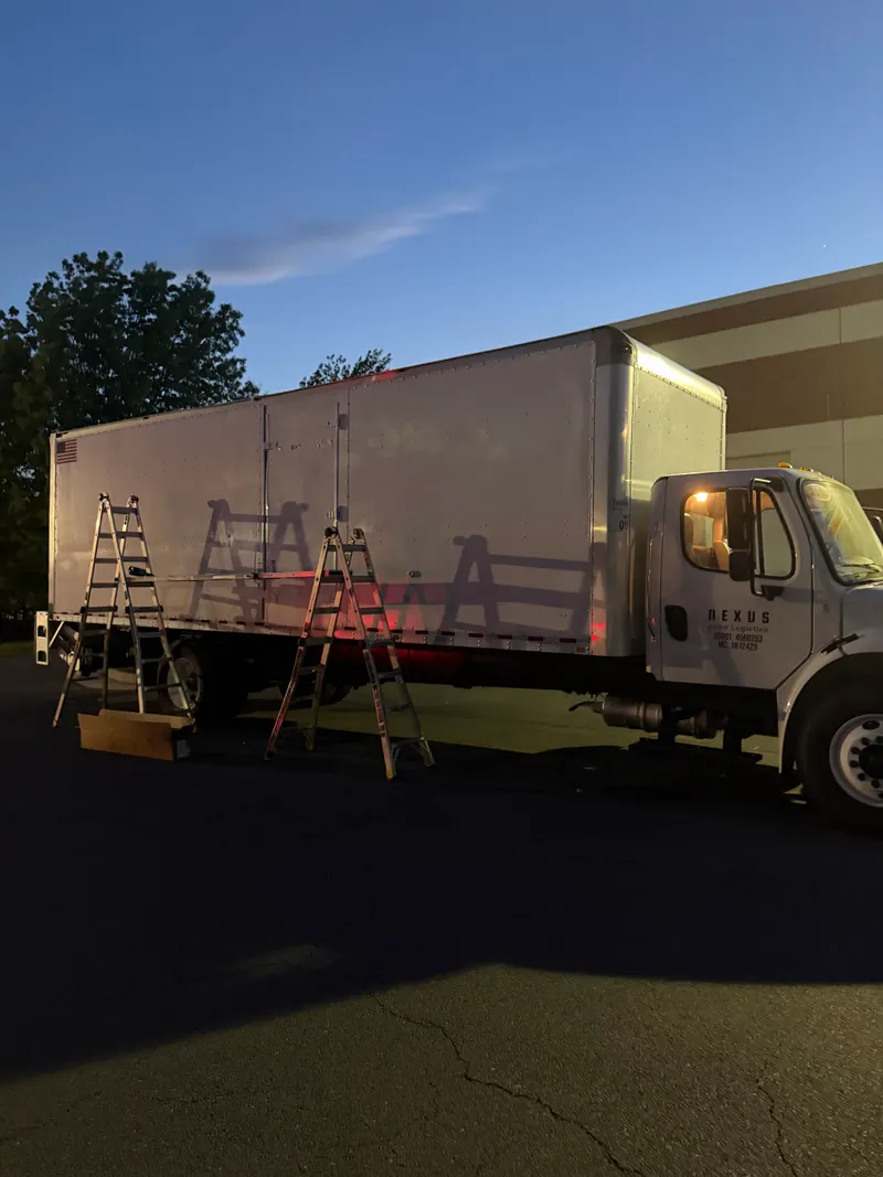 Unmarked box truck with ladders up at the start of a fleet job