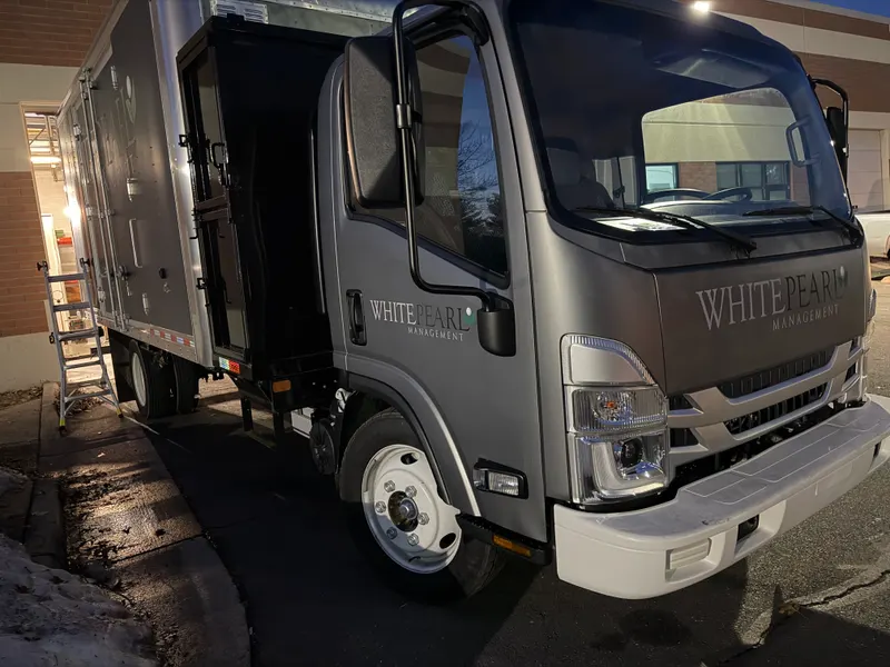 White Pearl Management truck door branding
